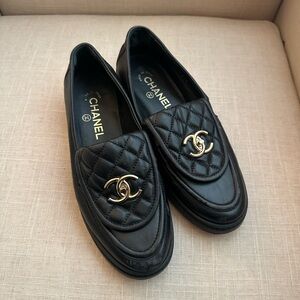 CHANEL Black Quilted Flats with Gold Logo